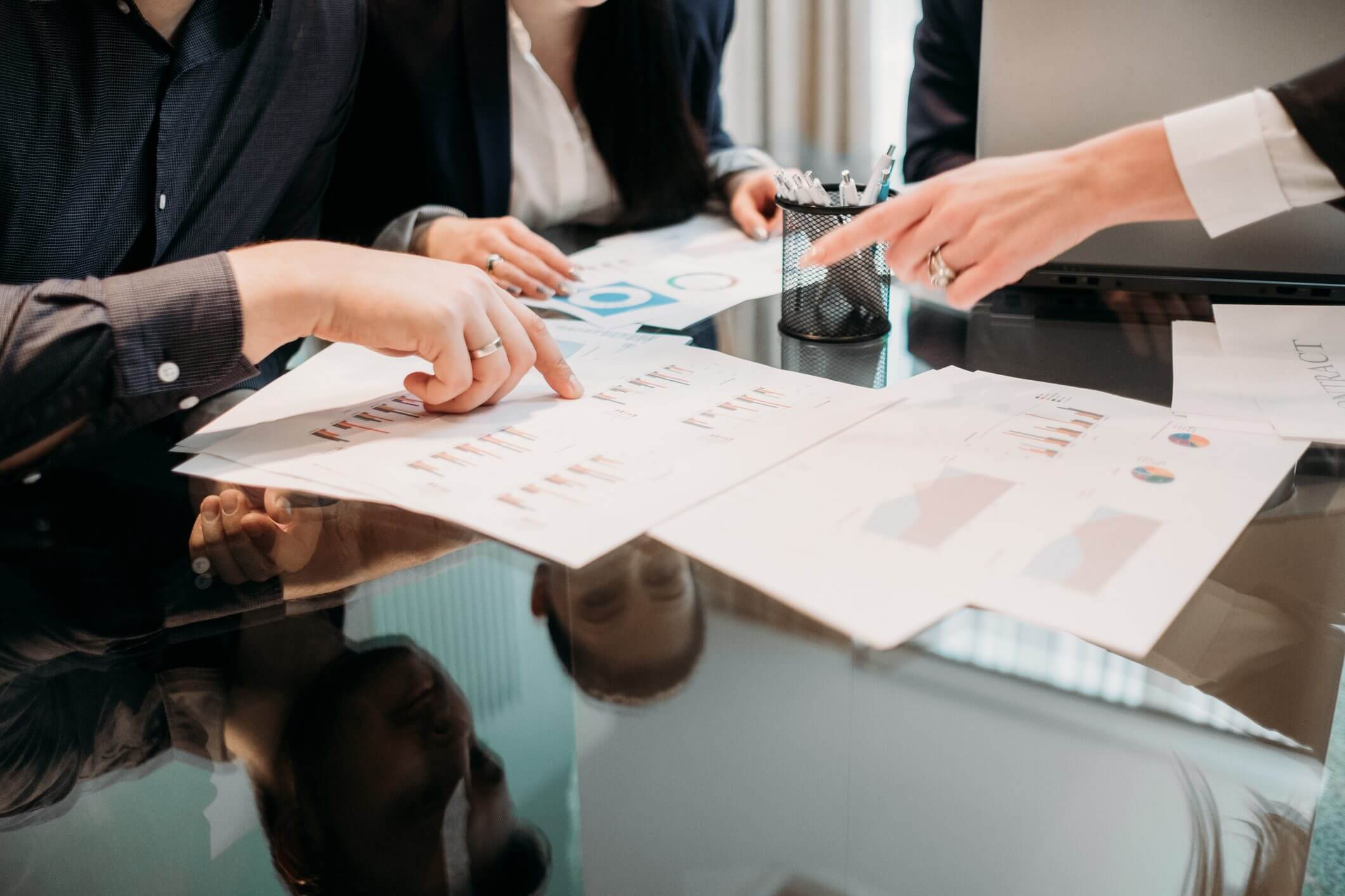 Business meeting with charts on table