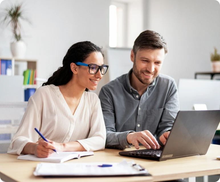 Colleagues collaborating on a laptop